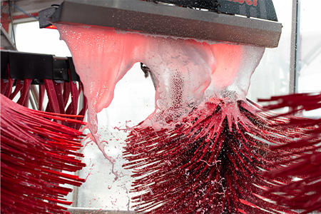 Image of Rainbow Coat at Tommy's Express with spinning red brushes in background